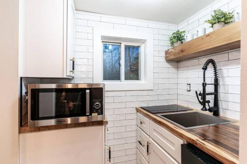 a kitchen with a microwave and a sink at Cozy Cabin in a rural setting in Temple,NH -12 in Temple