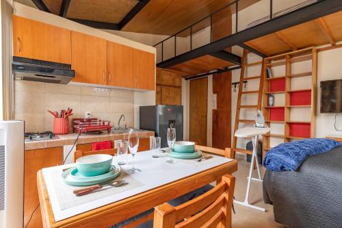 a small kitchen with a table in a tiny house at Lofts San Ángel in Mexico City