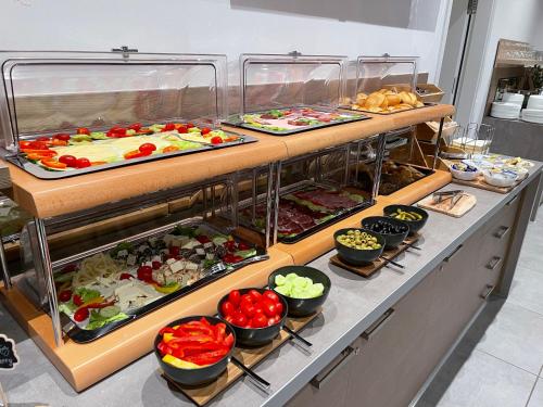 a buffet line with many different types of food at Palm Premium Hotel & Apartments in Düsseldorf