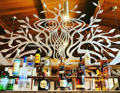 a chandelier above a bar with bottles of alcohol at Cabo Vista Hotel Adults Only in Cabo San Lucas