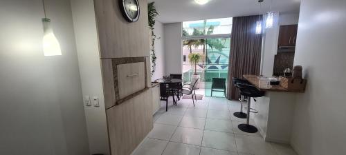 a room with a hallway with a clock on the wall at Excelente Apartamento Alto Padrão Centro Ed Dubai in Capão da Canoa