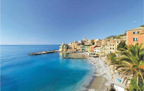 a view of a beach with palm trees and buildings at Casa Dellorchidea in Bracco