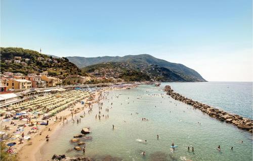 a group of people on a beach in the water at Casa Dellorchidea in Bracco