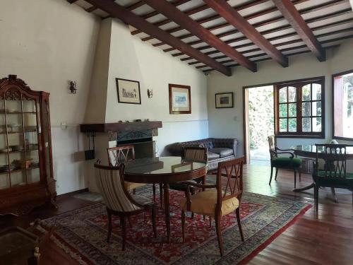 a living room with a table and chairs and a fireplace at La Cara Oculta de Salta, bed and breakfast in Salta