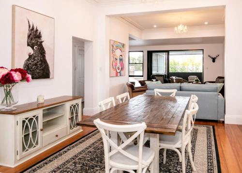 a dining room and living room with a table and chairs at The Wandering Grape in Mudgee
