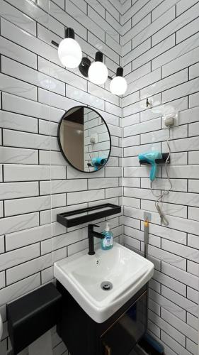 a white bathroom with a sink and a mirror at Bonjour Homestay in Sungai Pelik