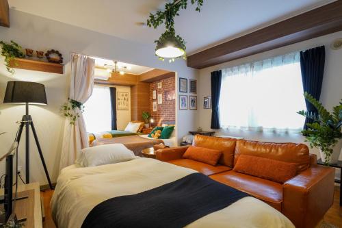 a living room with a bed and a couch at Rest52 inn in Sapporo