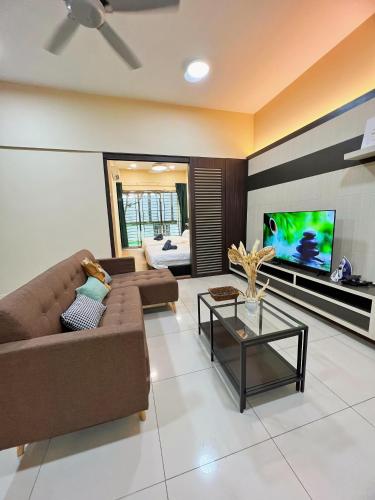 a living room with a couch and a flat screen tv at Maison life 小居屋 The Loft Imago in Kota Kinabalu