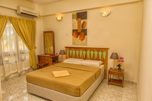 Ένα ή περισσότερα κρεβάτια σε δωμάτιο στο Kijal Permai Apartment
