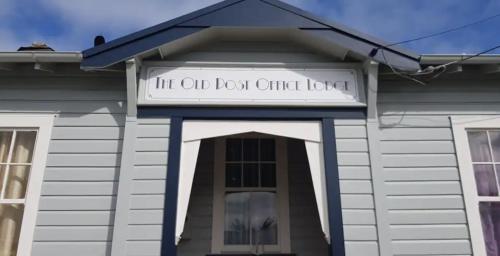 a building with a sign that reads lift old door chief load at Ruapehu's 5-Star OLD POST OFFICE - 1-4 Bdr West Wing in Owhango