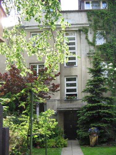 a building with a tree in front of it at Animrumru in Warsaw