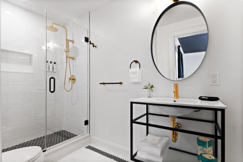 a white bathroom with a sink and a mirror at The Coach House in Salem