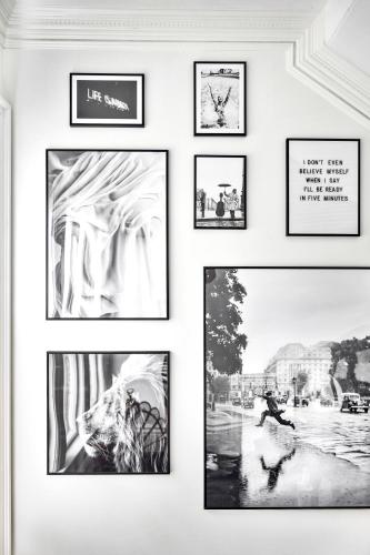 a group of framed pictures on a wall at The Coach House in Salem