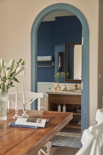 a dining room with a table and a mirror at Florence Villa - Novaworld Phan Thiet in Phan Thiet