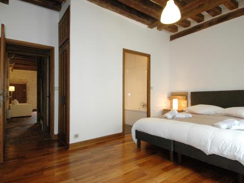 a bedroom with a large bed and a bathroom at Appart'Tourisme Blois Châteaux de la Loire in Blois