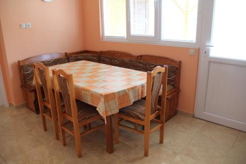 a dining room table and chairs with a checkered table cloth on it at U Mami in Veľký Meder