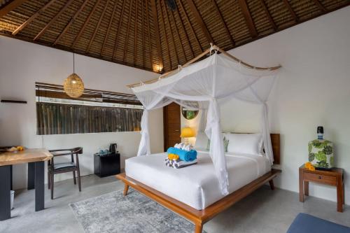 a bedroom with a bed with a canopy at Villa Markisa Echo Beach in Canggu
