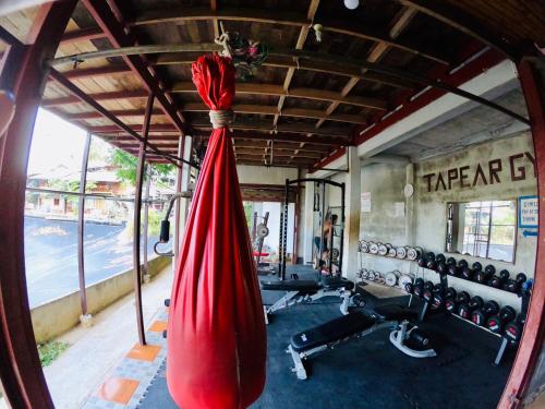a gym with a red hammock and weights at JR&GYM Resort in Phi Phi Don