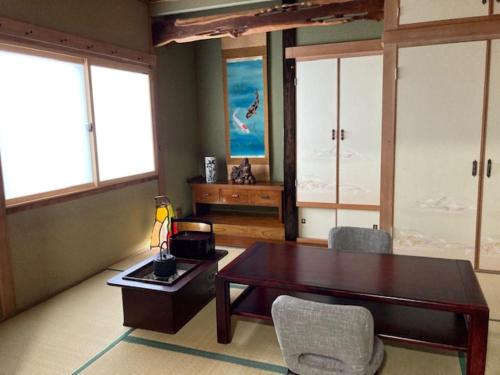 a living room with a wooden table and chairs at SPR港家 in Kamuenai