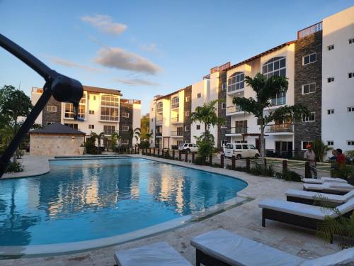 a swimming pool in front of some apartment buildings at Armonia De Las Terrenas Gorgeous Penthouse in Las Terrenas