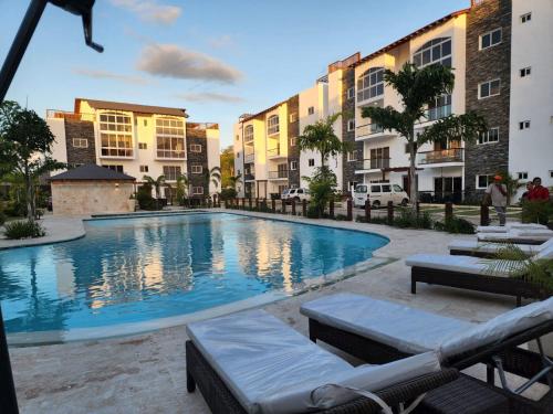 a swimming pool in the middle of some buildings at Armonia De Las Terrenas Gorgeous Penthouse in Las Terrenas