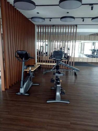a room with chairs and tables in a building at SS CondoStay Residensi Lili, Nilai nearby KLIA, USIM - infinity pool, wifi, smart tv in Nilai