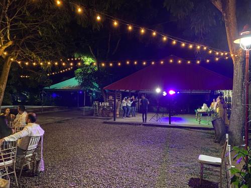 a group of people sitting in chairs under a tent with lights at Cabaña Villa Mary-Aguachica in Aguachica