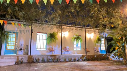 a room with chairs and a wall with flags at Cabaña Villa Mary-Aguachica in Aguachica