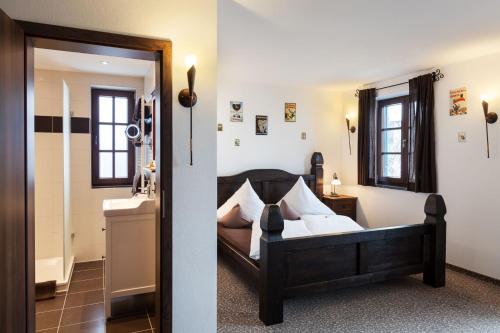 a bedroom with a bed and a sink and a mirror at Vitusfort Appartement "Guinness Suite" in Füssen