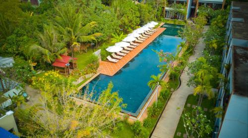 an aerial view of a swimming pool with umbrellas at Khmer House Resort in Siem Reap