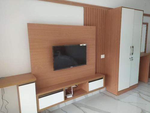 ein Wohnzimmer mit einem Flachbild-TV an der Wand in der Unterkunft Seeheim Resorts in Athirappilly
