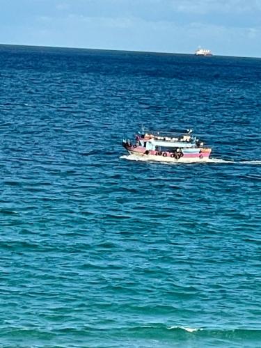 a boat in the middle of the ocean at Alzohour Family condo with panoramic sea view in Alexandria
