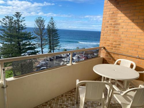 a balcony with a table and chairs and the ocean at Park Towers-Goodwin Towers Holiday Units in Gold Coast