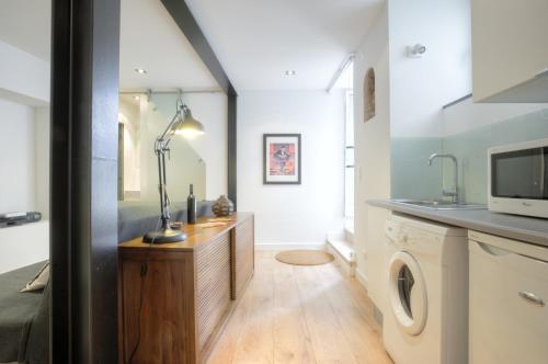 a laundry room with a washer and dryer at BmyGuest - Castelo Charming Flat in Lisbon