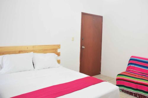 Un ou plusieurs lits dans un hébergement de l'établissement Hostal Casa Bohemia