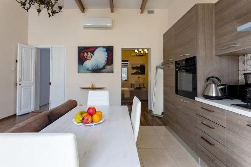 a kitchen with a table with a bowl of fruit on it at Modern stylish flat near Valletta and Sliema! in Msida