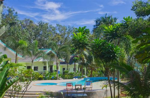 a resort with a swimming pool and palm trees at Sea View Resort in Ko Mak