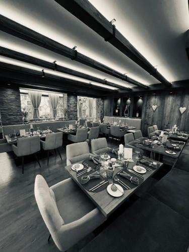a dining room with a long table and chairs at Hotel Central in Ischgl