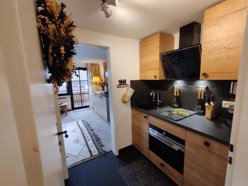 a kitchen with a black counter top and wooden cabinets at Schittlerhof in Fischen