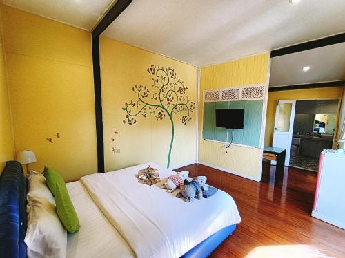 a bedroom with a bed with teddy bears on it at Aen Guy Boutique Hotel in Sukhothai
