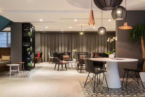 a lobby with a table and chairs and a bar at Mercure Lille Centre Vieux Lille in Lille