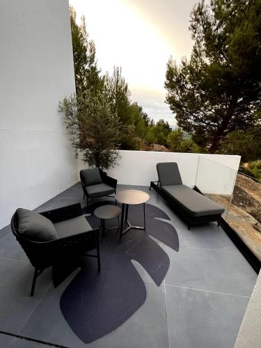 a patio with two chairs and a table and chairs at Suite 28 in Treilles