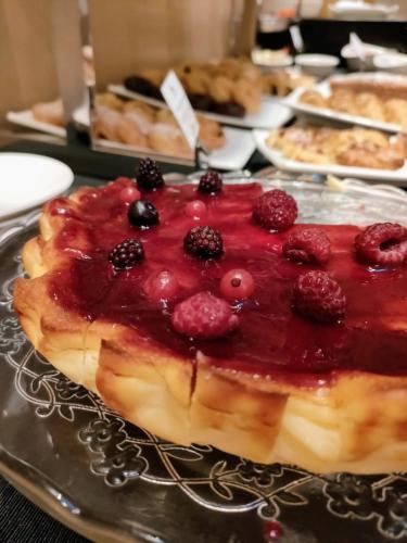a dessert with berries on top of it on a plate at Hotel Alfonso in Zaragoza