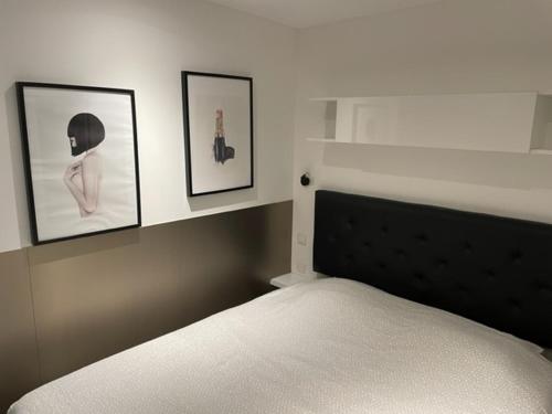 une chambre avec un lit avec trois tableaux au mur dans l'établissement Sexy Waïki Port Nature 6, au Cap d'Agde