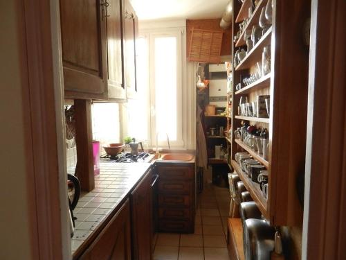 a kitchen with a sink and a stove top oven at Very large private room with own bathroom, in Montmartre apartment in Paris