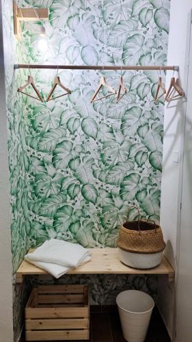 a wall with a green and white wallpaper at Ecorooms Ferrara in Ferrara