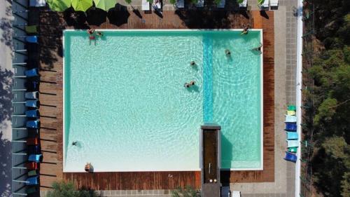 an overhead view of a swimming pool with people in it at Floating House Embé Experience in Castel Volturno