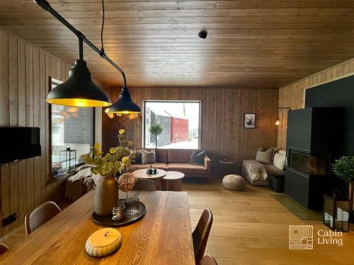 a living room with a table and a couch at Brand new Chalet-apart slope Hafjell Mosetertoppen in Øyer