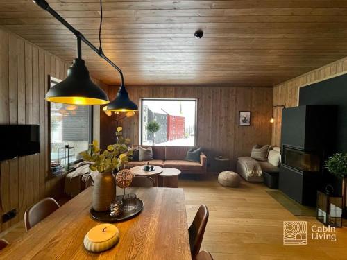 a living room with a table and a couch at New ski in-out apartment with sauna in Hafjell in Øyer