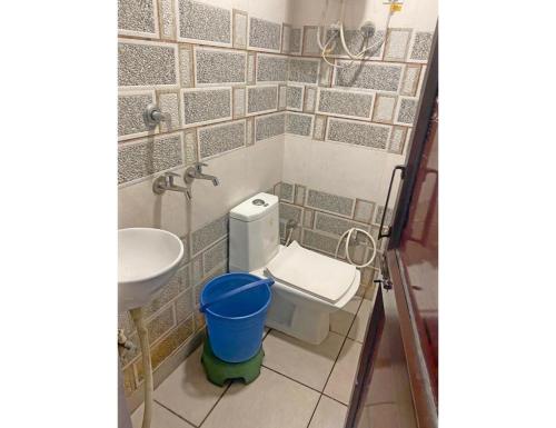 a bathroom with a toilet and a sink at Smart Guest House, Panipat in Pānīpat